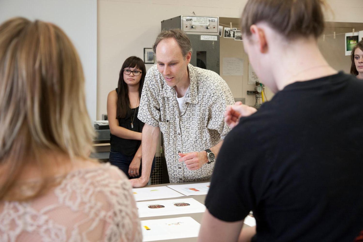 faculty working together around table