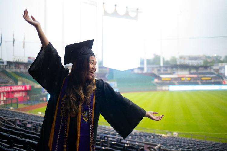 Female student flings out her arms.