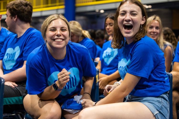 two students smile at Convocation